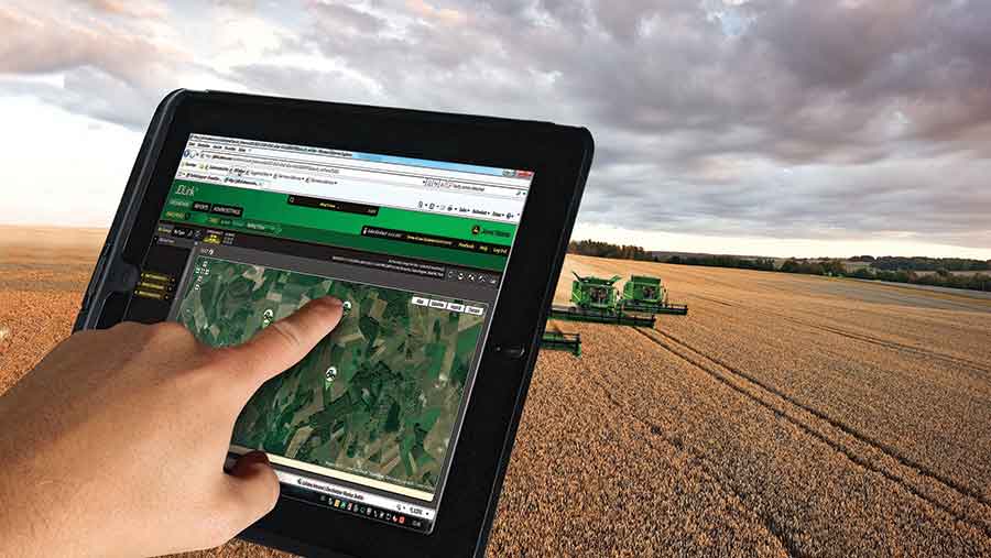 Hand typing on tablet in combine cab