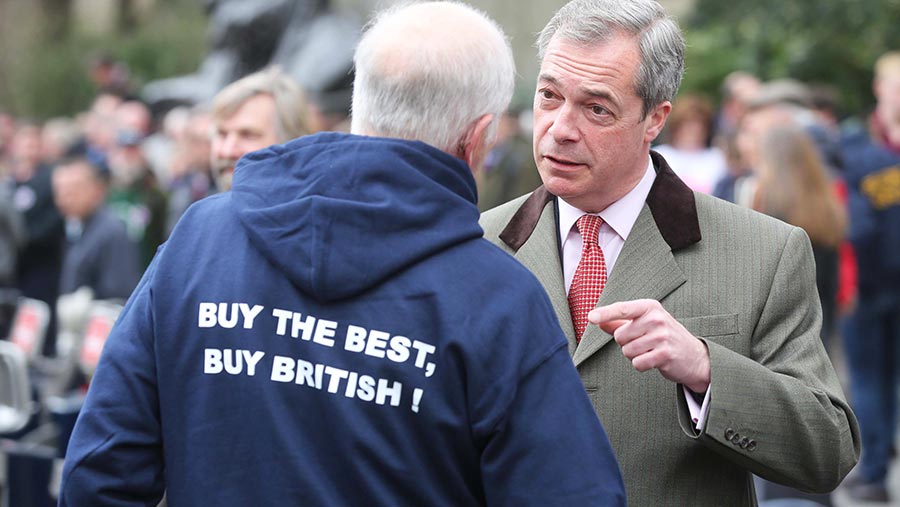 Nigel Farage talks to a farmer © Tim Scrivener