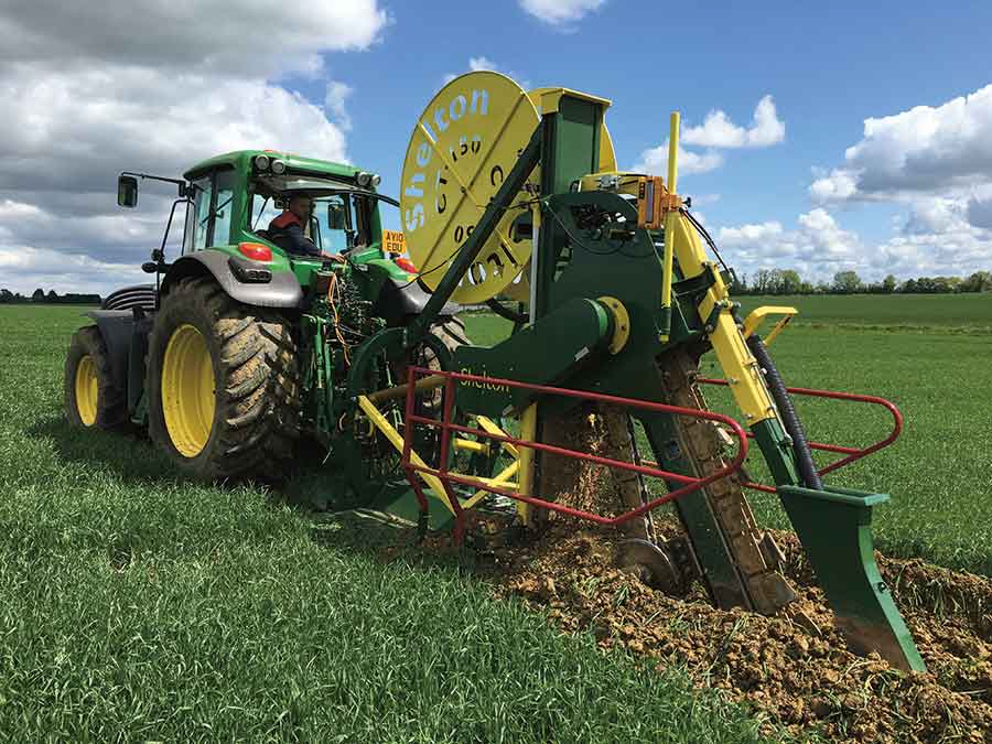 Laying pipes with the trencher