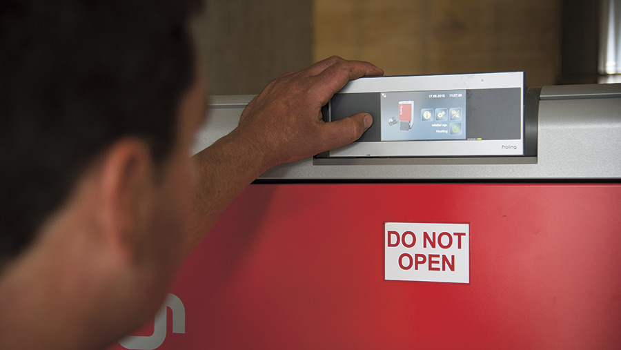 Hand reaching out to control of a biomass boiler