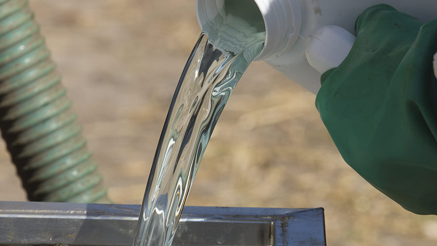 Liquid chemicals are poured into a sprayer