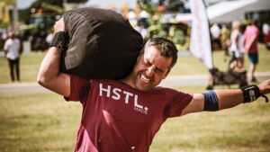 Britain's Fittest Farming contestant lifting weighted bags