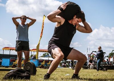 Britain's Fittest Farming contestant lifting weighted bags
