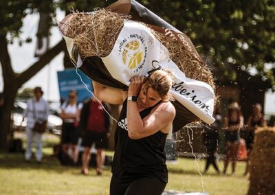 Britain's Fittest Farming contestant lifting hay bag