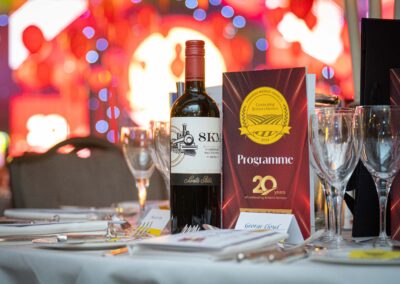 Table set with a bottle of wine and wine glass at the Farmers Weekly Awards