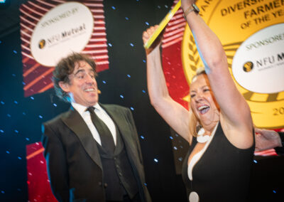 Farmers Weekly Awards host Stephen Mangan with award winner on stage