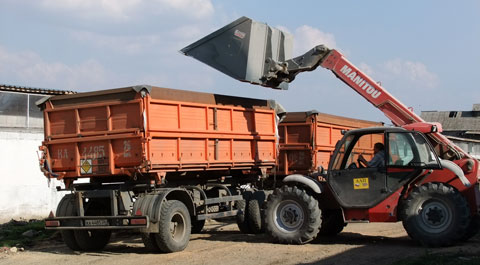 Loading grain with one of the farm's two Manitou telehandlers